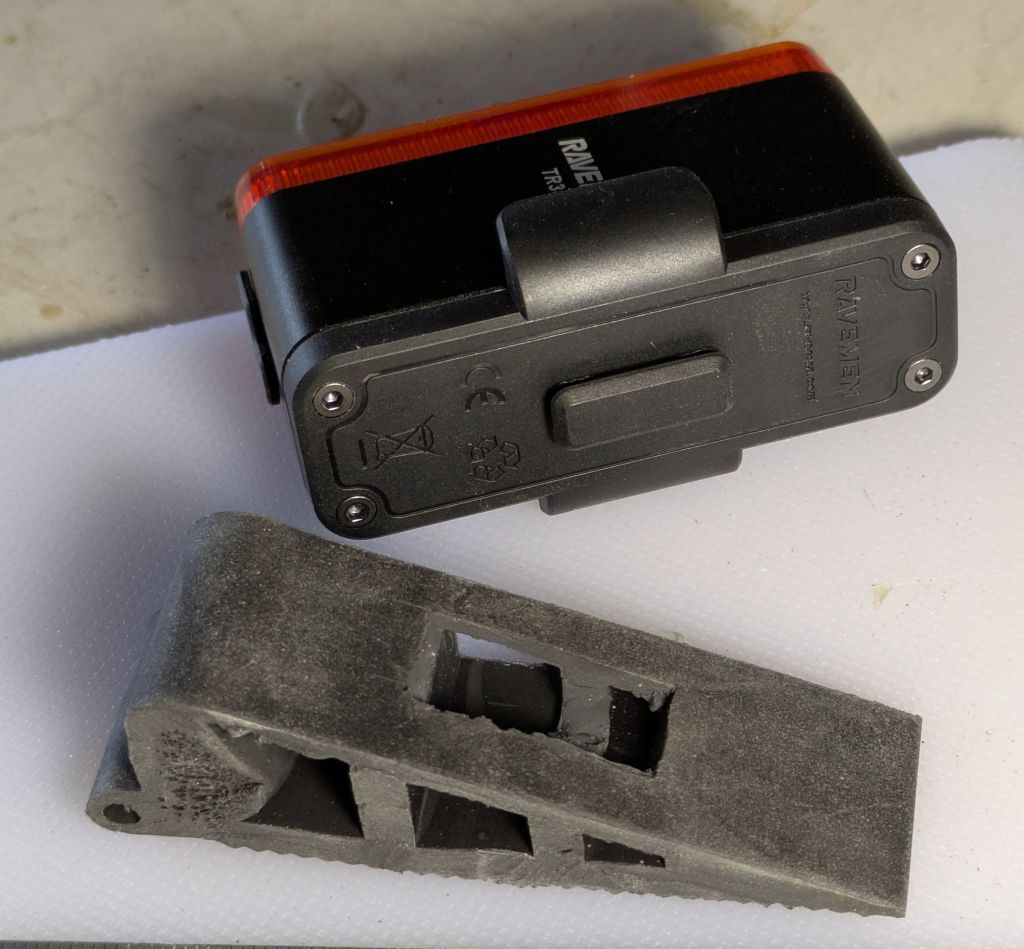 Image of a rubber door stop modified to accommodate a rear bicycle light